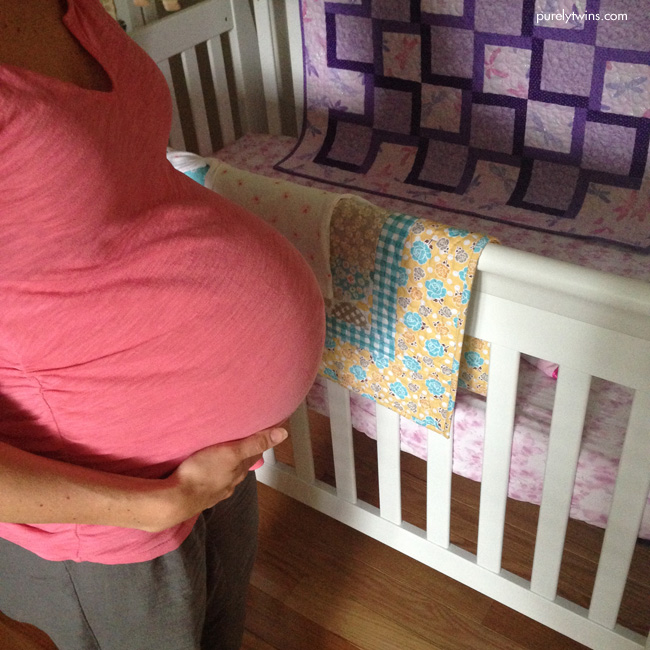 mom-to-be-in-nursery-baby-crib