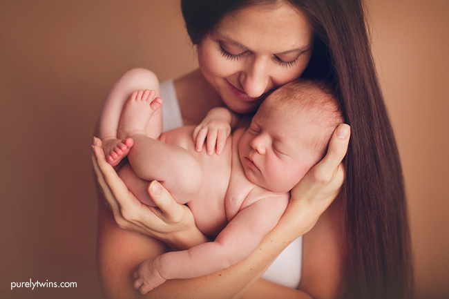 new-mom-holding-baby-girl-newborn-photos