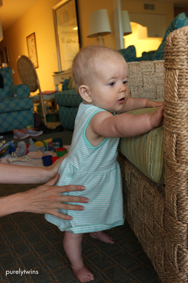 8 month old baby holding chair to stand up on her feet #babygirl #8monthsold #babystanding