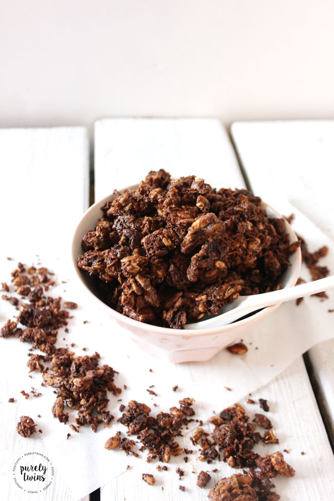 10 ingredient super easy and healthy Chocolate Granola recipe. Just sweet enough and spiced perfectly with a hint of dark chocolate and tahini. Tahini is not just for hummus it goes perfect with chocolate for one rich, oh so satisfying breakfast bowl of goodness. 