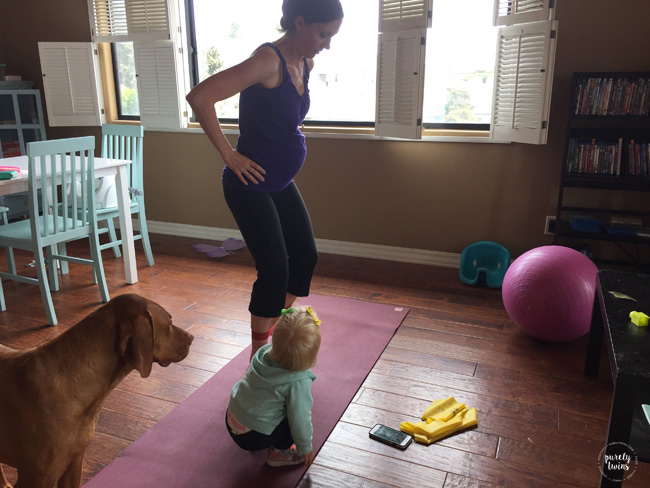 Mom trying to work out with her toddler running around