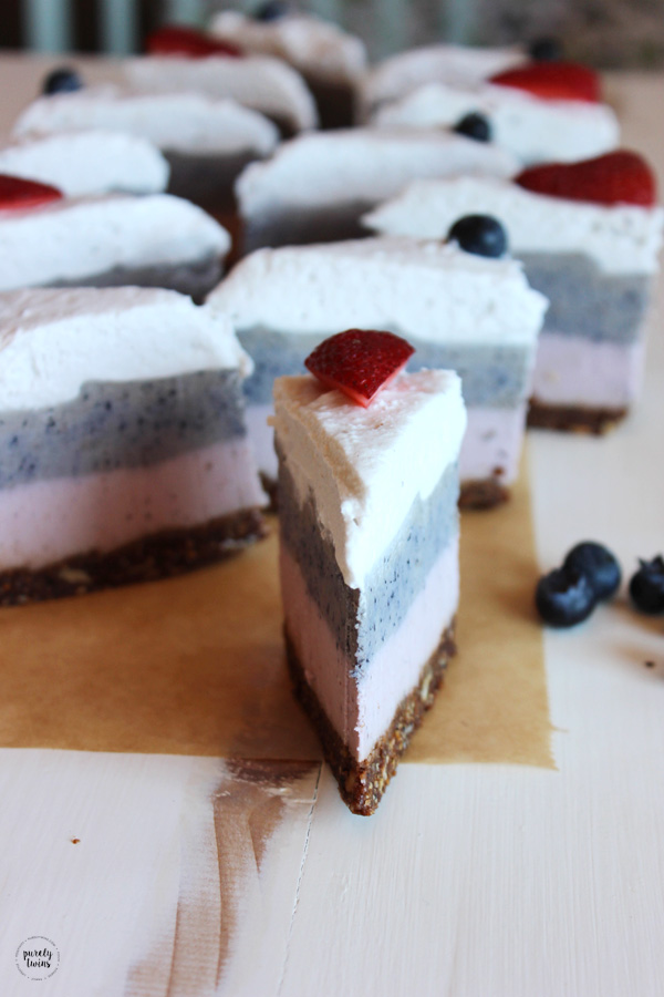 Elevate your raw cheesecake experience with a triple layered berry red, white and blue creamy layers with a tasty chocolate granola based crust. This No Bake Strawberry Blueberry Layered Cheesecake is super easy to make and a big hit! It kept it super simple with using fresh berries on top to bring a burst of more color. And they always look great on top of desserts where you want things to look pretty and festive. Perfect for a summertime treat or July 4th celebration!