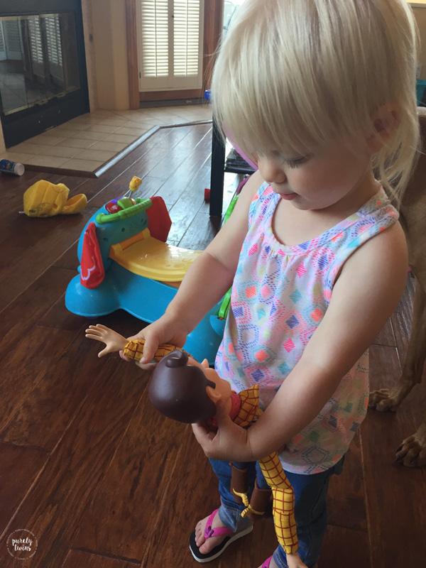 Toddler girl getting Disney's Toy Story Woody doll