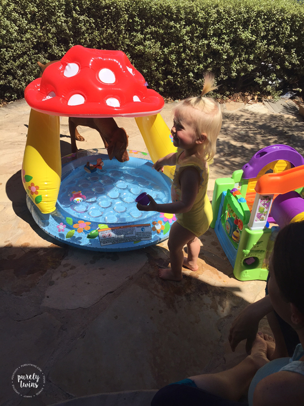 toddler-playing-in-tinkerbell-bathing-suit-outside
