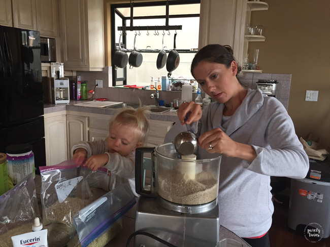 Mom and 2 year old in the kitchen together making recipes.