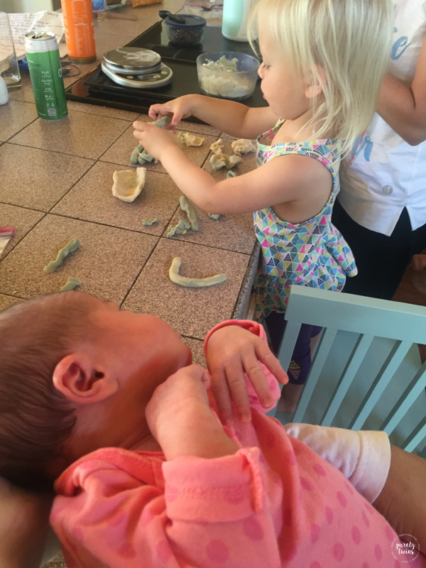 Baby watching older sister play with homemade play dough