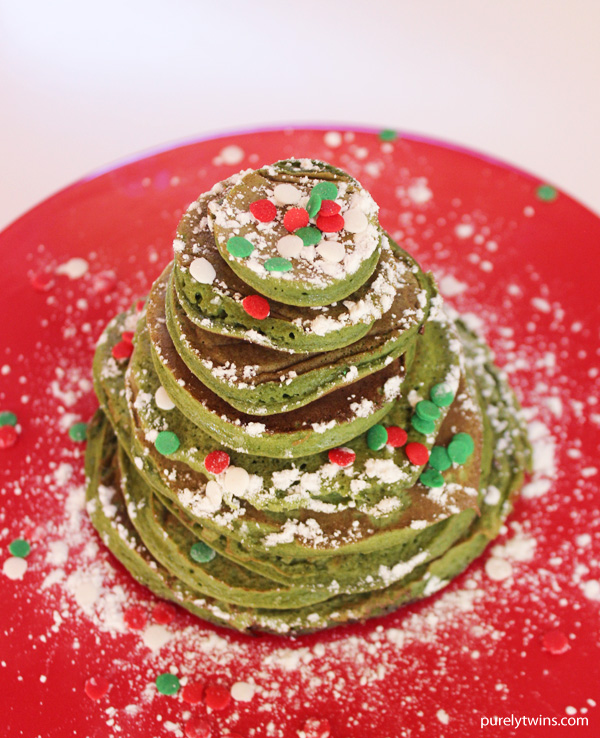 Flourless gluten-free grain-free plantain pancakes packed with spinach and perfect fit protein. Make a new holiday memory this year with these fluffy Christmas Tree Pancakes. Protein powder adds a boost in protein to this traditional flourless pancake batter recipe. No green food coloring needed as spinach adds in the green. Top the Christmas tree pancakes with mini candy “ornaments” aka sprinkles and a dusting of powdered sugar “snow” make this holiday breakfast idea festive, flavorful and fun!