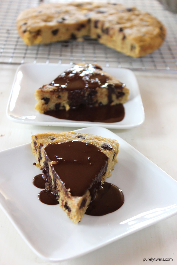 The BEST chocolate chip cookie cake recipe with hot fudge sauce. This cookie cake recipe is super easy to make. A warm, rich chocolate explosion for any occasion. No gluten. No grains. No dairy. No eggs. Making this the perfect cake for everyone to enjoy anytime. Made from plantains, coconut oil and a little maple. 