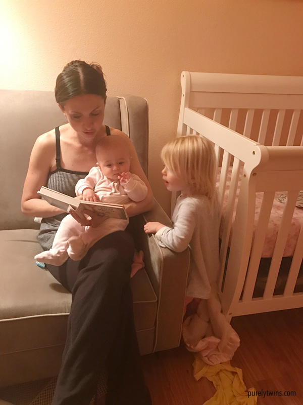 Mom reading bed time stories to her two little girls