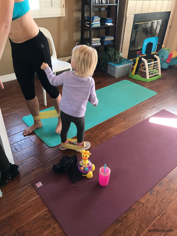 Mom working out as her daughter joins her