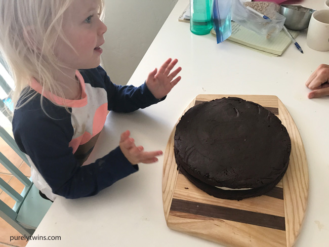 2 year old helping with oreo birthday cake