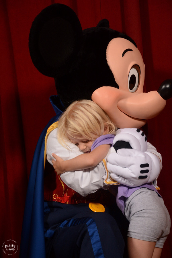 best mickey mouse picture giving toddler girl a hug magic kingdom talking mickey