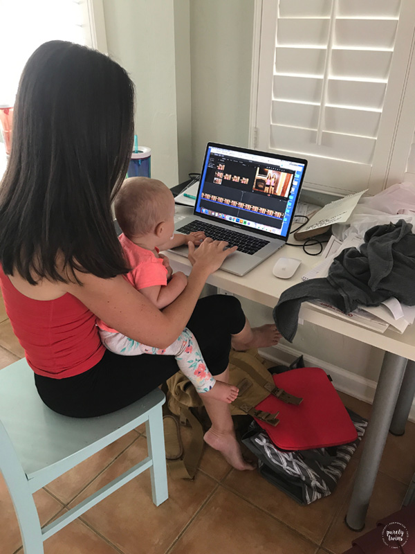 baby on aunt's lap doing computer work - working from home