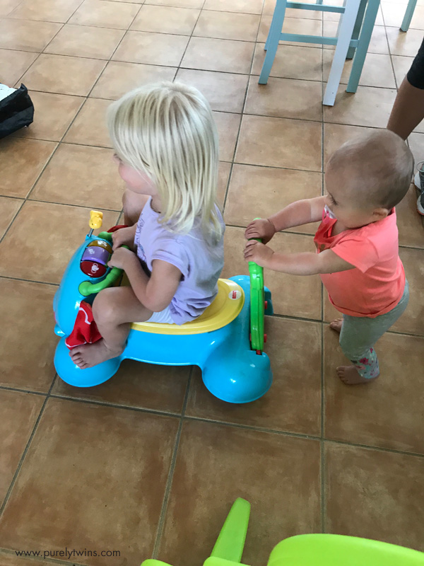 Little sister pushing big sister